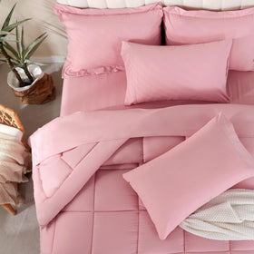 Downcool pink bedroom setup showing coordinated bedding on bed