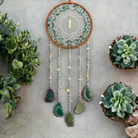 Dreamocean boho crystal dream catcher in green turquoise window catching sunlight and creating soft glow
