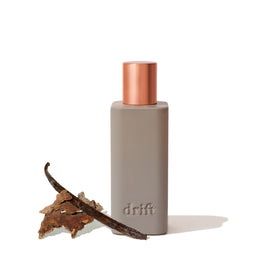 Drift Vanilla Woods room spray bottle releasing warm vanilla aroma to refresh living spaces