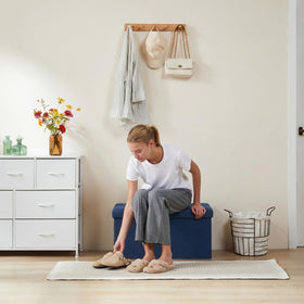 DUMOS end-of-bed bench in blue with large storage capacity for bedding.