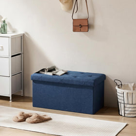DUMOS blue ottoman as a coffee table surface with clean, versatile use.