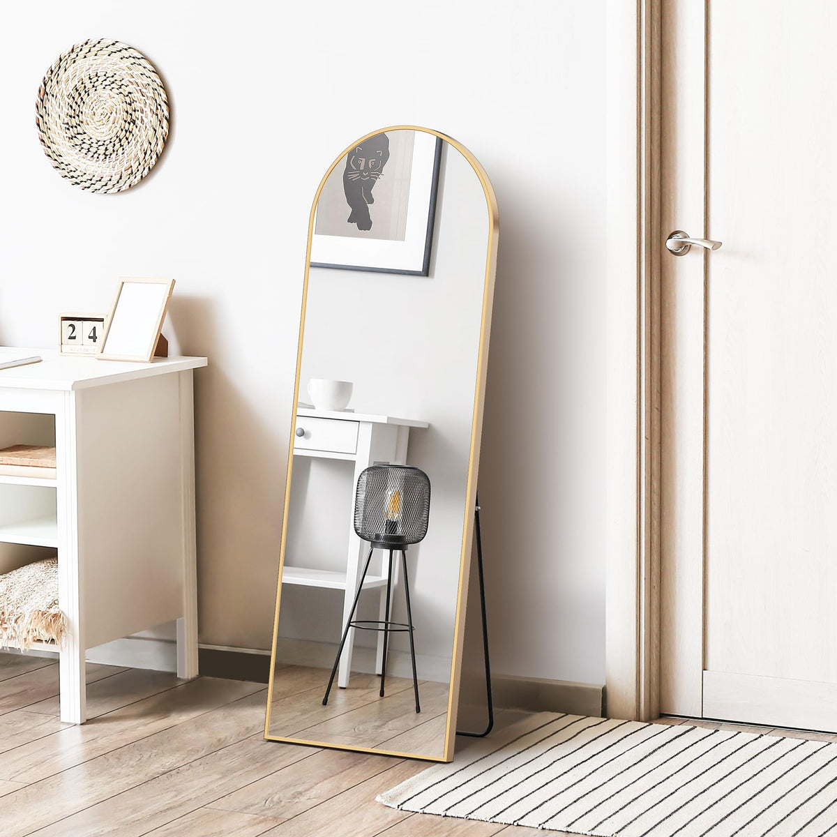 DUMOS slim-profile gold mirror complements contemporary decor and saves floor space.