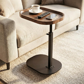 Eansstofars adjustable-height TV dinner tray under a sofa for easy reach.