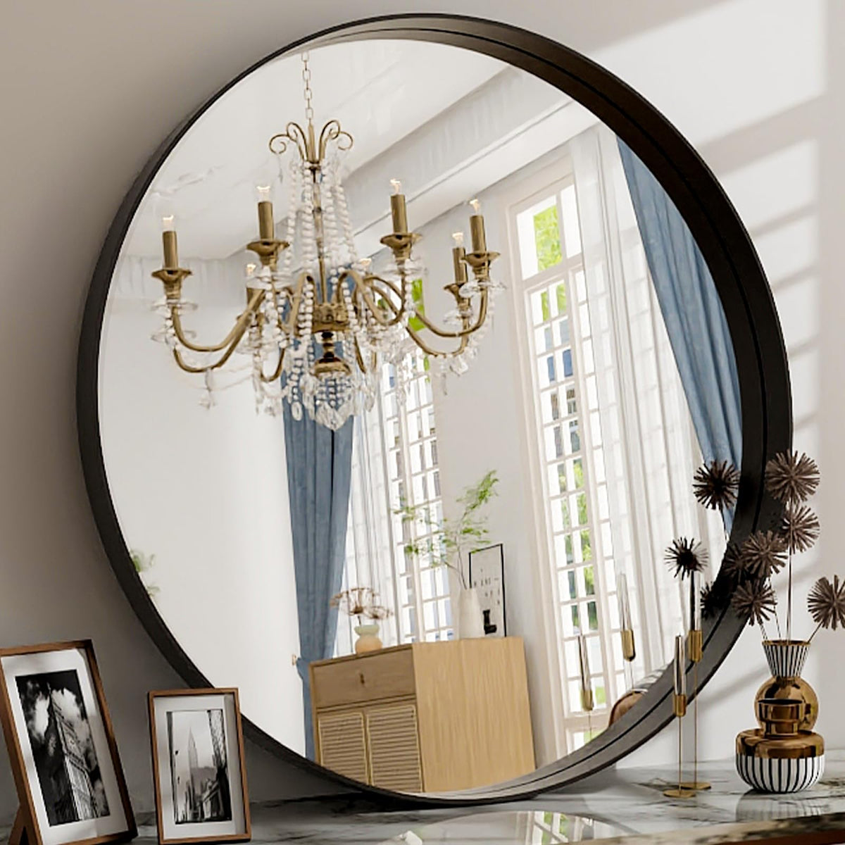 Easly 24-inch round mirror with black frame, front view showing modern circular design and reflection.