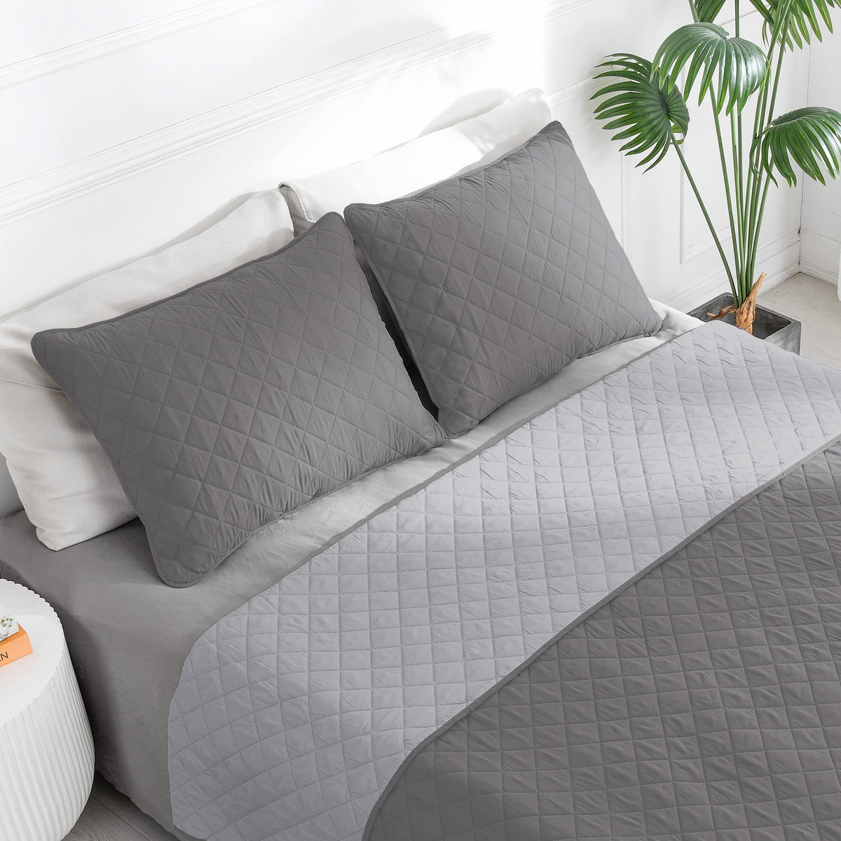 Easy-Going reversible quilt in gray on bed offers versatile year-round layering.