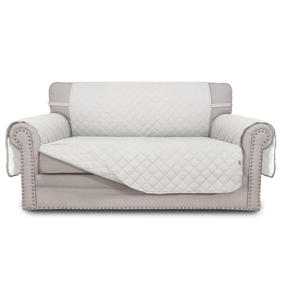 Easy-Going reversible loveseat cover on sofa; protects against daily wear.