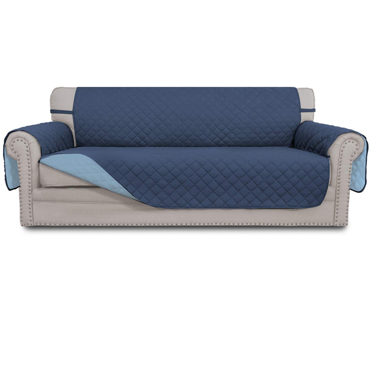 Easy-Going reversible couch cover on a dark blue sofa shields three-cushion seating from spills.