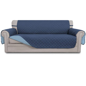 Easy-Going reversible couch cover on a dark blue sofa shields three-cushion seating from spills.