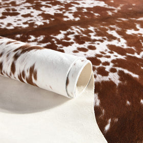 Easycozy cowhide rug on wood floor enhances rustic, western-inspired decor.