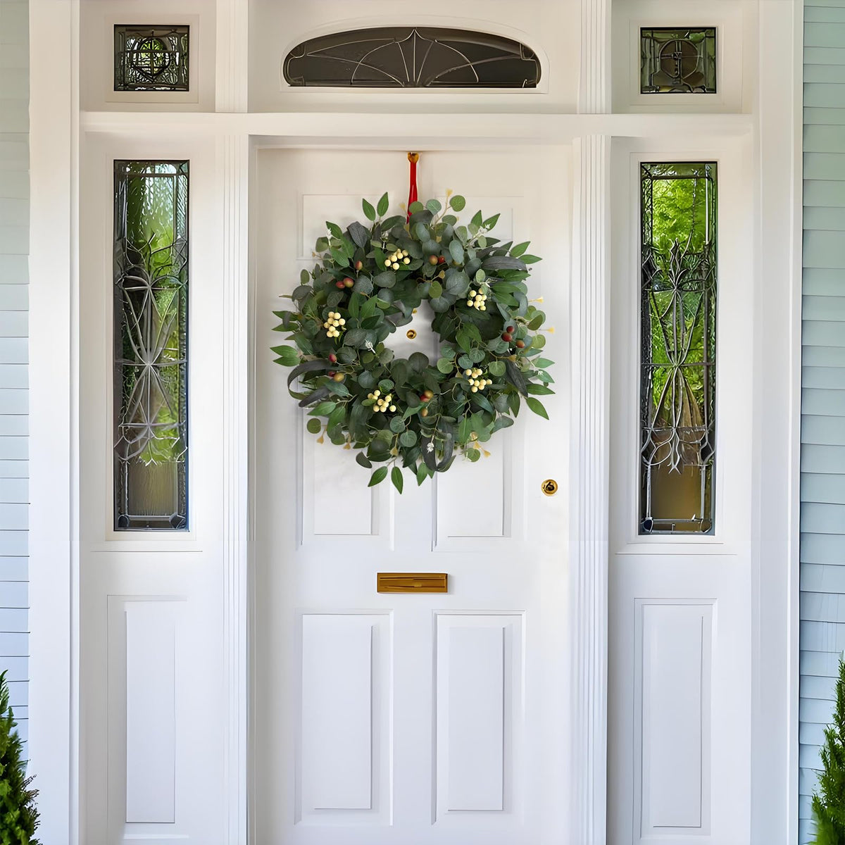 Ecerangus wreath with olive leaves and berries adds natural charm.