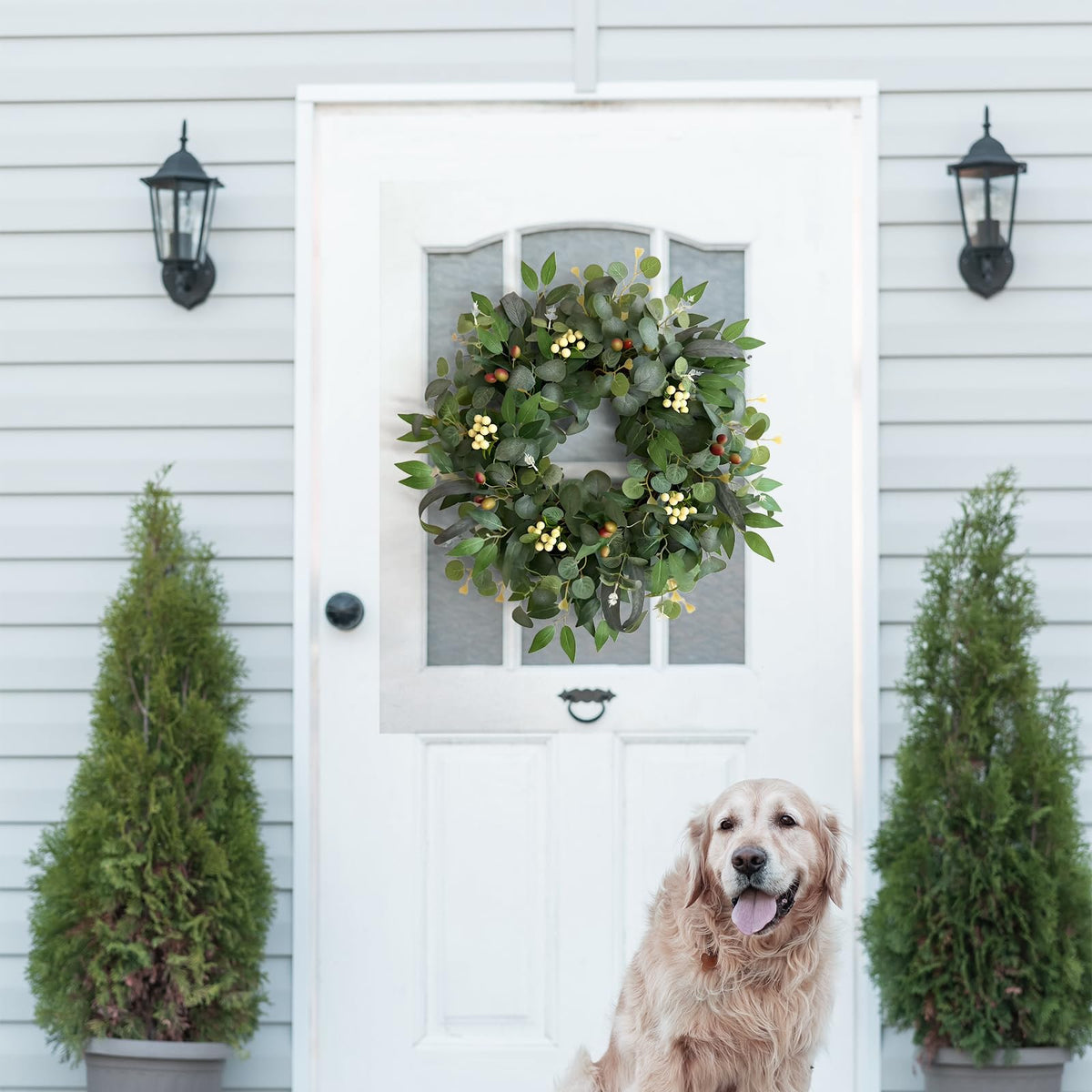 Handcrafted eucalyptus wreath blends greens white berries and olive accents.
