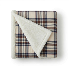 Eddie Bauer Sherpa throw blanket on a couch showing ultra-soft fleece and plush sherpa warmth