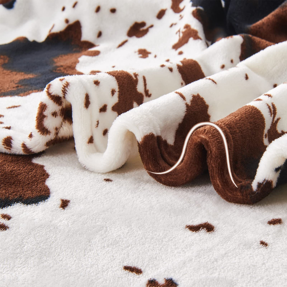 Edenleaf cow print blanket for camping and outdoor moments.