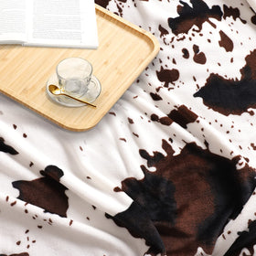 Edenleaf cow print blanket closeup fabric detail shows durable weave.