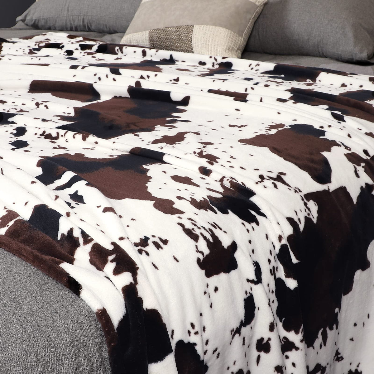 Edenleaf cow print blanket nap time in soft close-up fabric.
