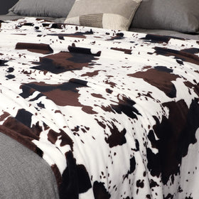 Edenleaf cow print blanket nap time in soft close-up fabric.