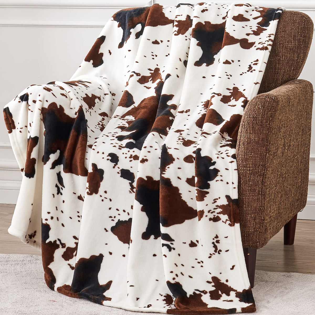 Edenleaf cow print blanket on the sofa for cozy evenings.