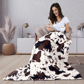 Edenleaf cow print blanket for travel and on-the-go comfort.