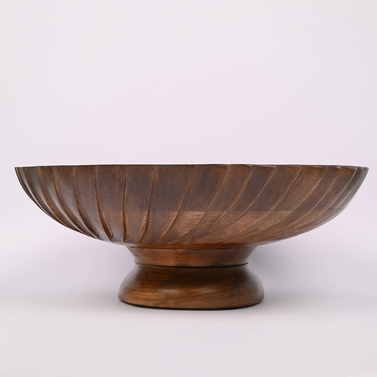 EDHAS mango wood bowl with floral arrangement adding natural color accents.