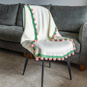 EIGHTOWN cozy throw draped on a sofa invites relaxation.