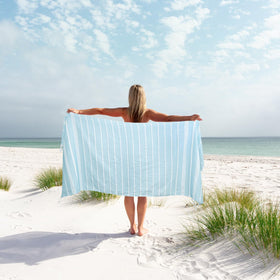 Sand-free weave demo of Eliamo blue towel for beach days.
