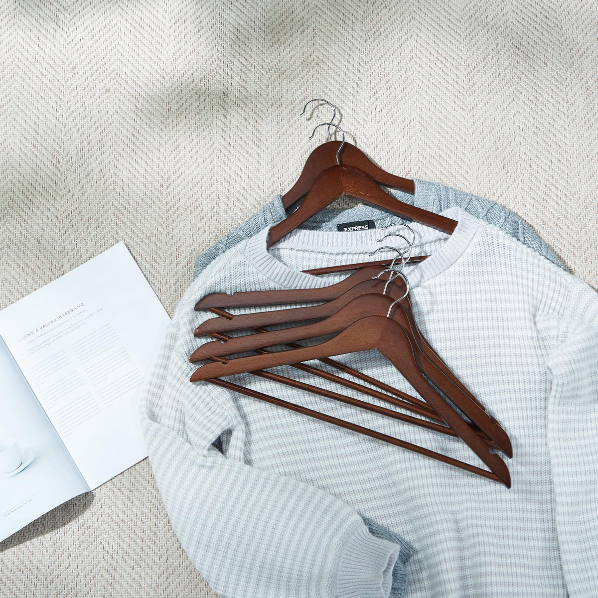 ELONG HOME hanger showing ergonomic shoulder design to help maintain garment shape.