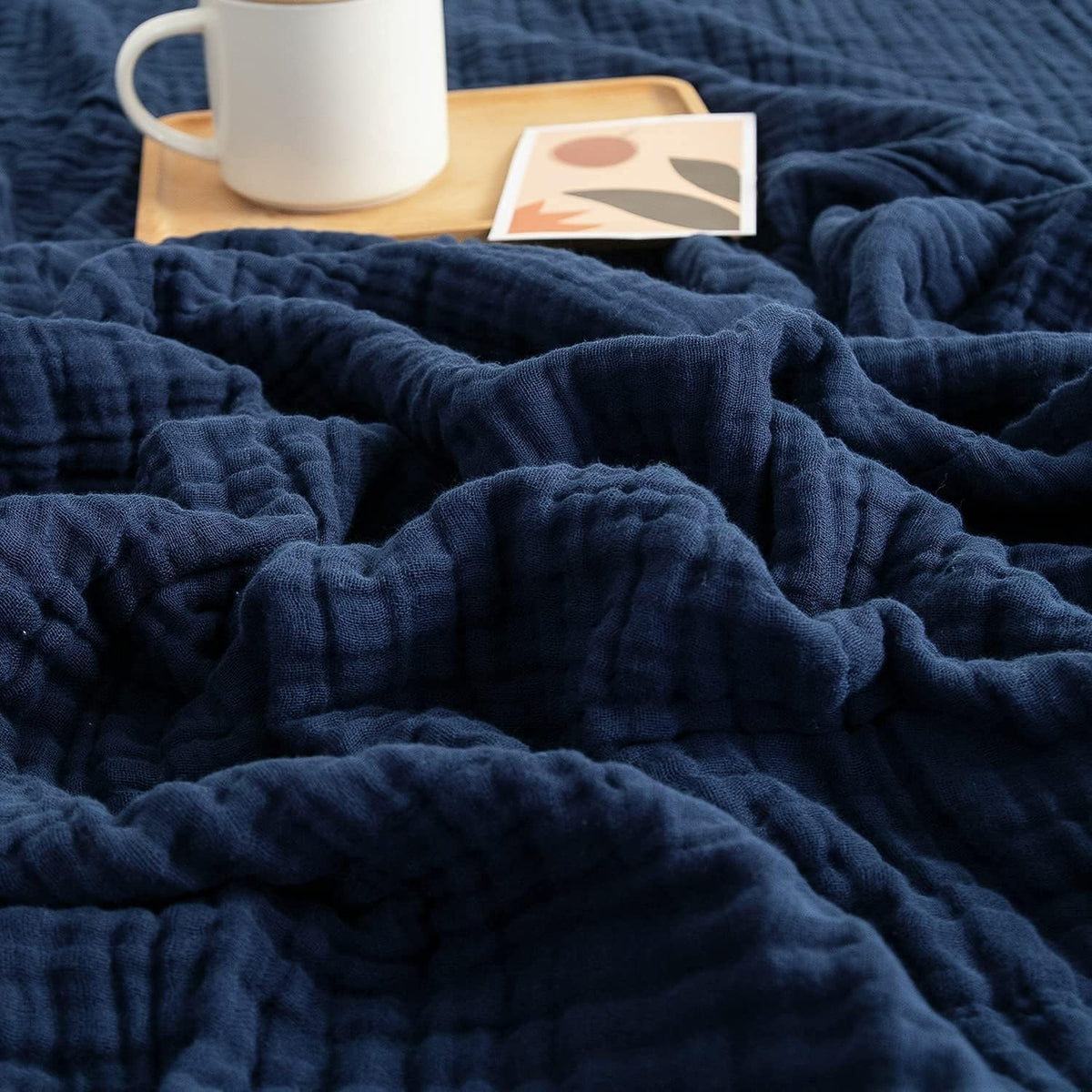 EMME cotton blanket in navy shows soft, breathable fabric for all-season comfort.