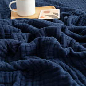 EMME cotton blanket in navy shows soft, breathable fabric for all-season comfort.
