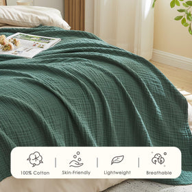 EMME cotton muslin blanket on bed offers lightweight warmth and drape.