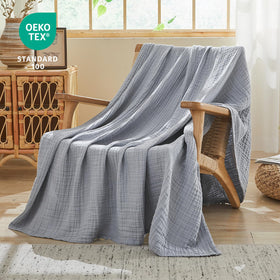 EMME blanket on a bed shows breathable four-layer muslin fabric