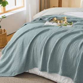 Nursery-ready crib coverage with EMME muslin blanket for gentle warmth.
