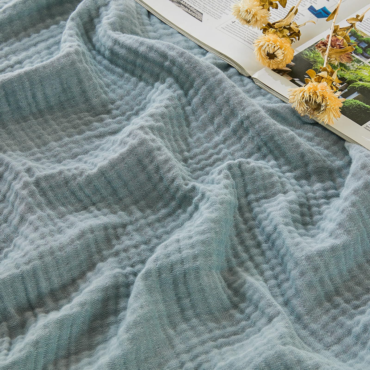 EMME cotton muslin large throw blanket on couch, breathable comfort for evenings.