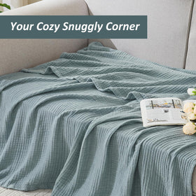 Travel-ready EMME throw blanket folded for easy packing on trips.