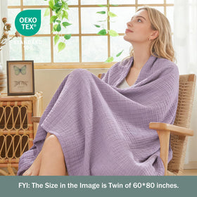 EMME cotton throw blanket showcased on living room couch for relaxed evenings.