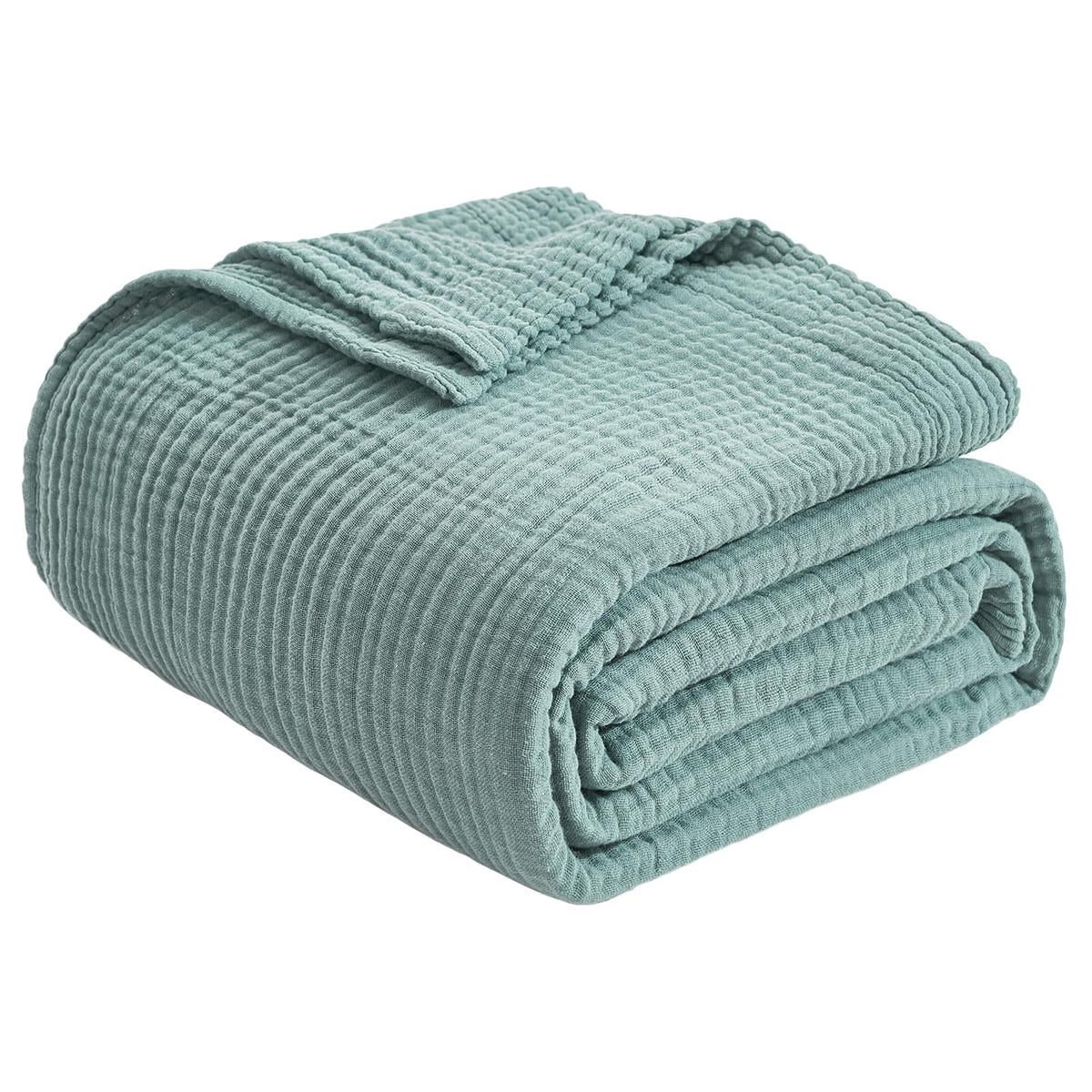 EMME cotton throw blanket on sofa in teal, adding cozy texture to living spaces.