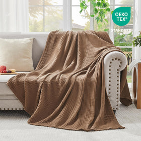 EMME couch with blanket draped to highlight versatility