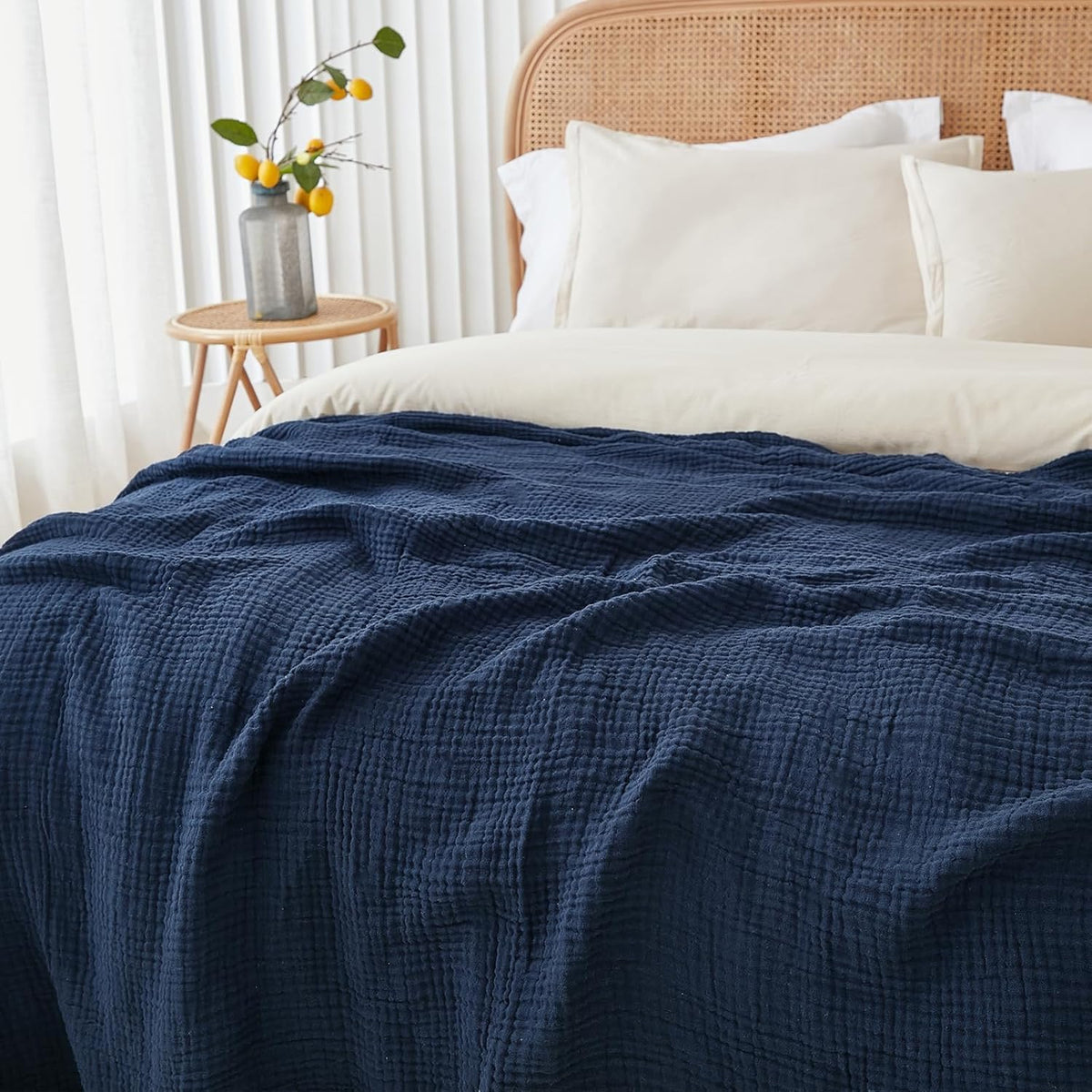 EMME muslin blanket on sofa showcases cozy all-season comfort.