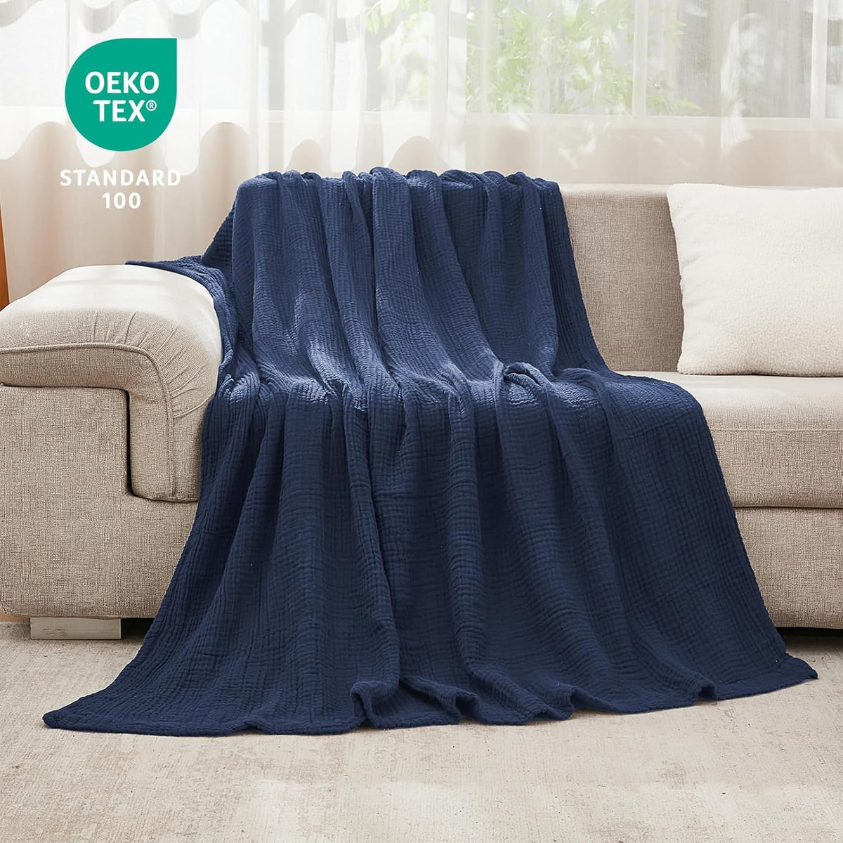 EMME muslin blanket travel-size presentation emphasizes lightweight portability.