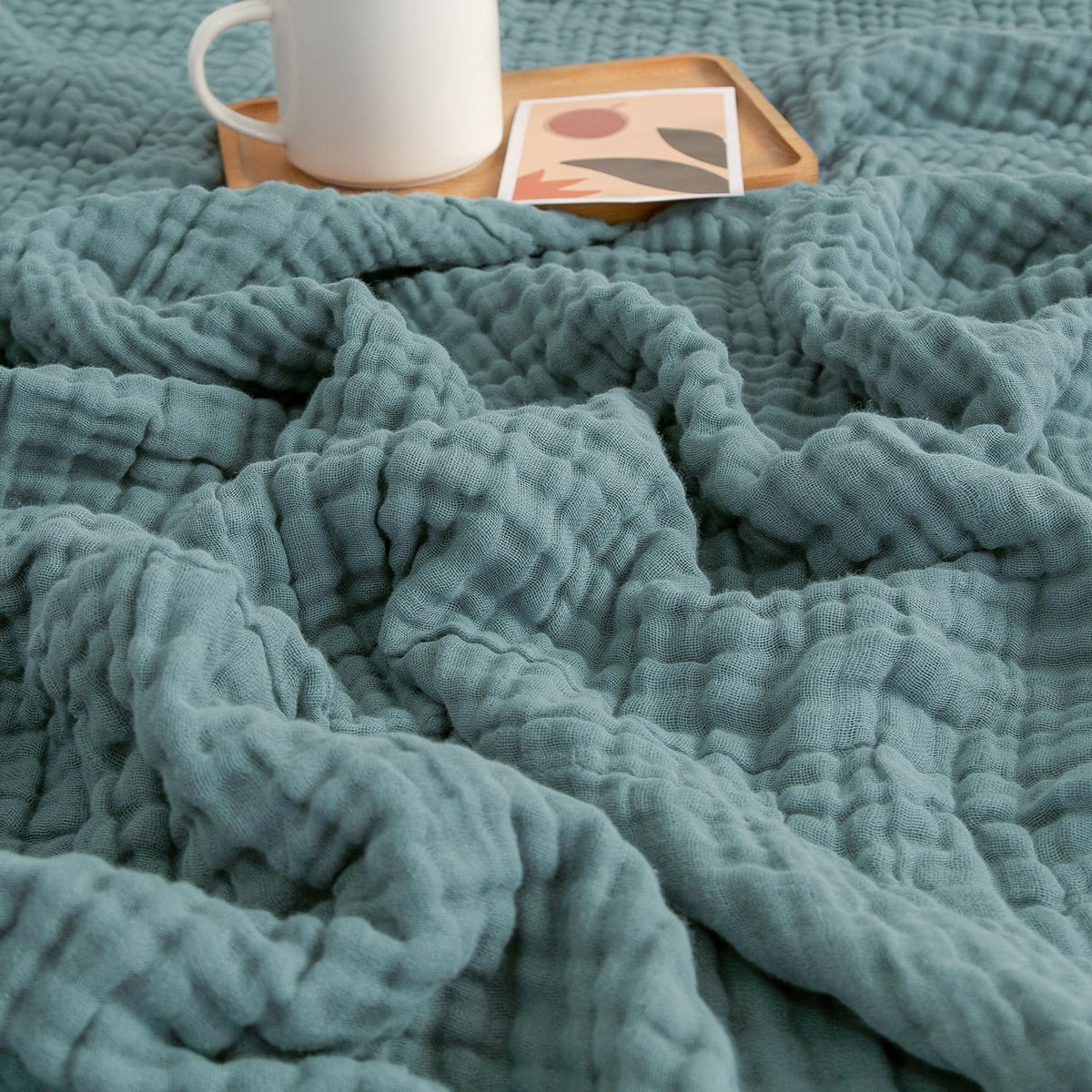 EMME muslin throw blanket teal closeup texture for breathable softness.