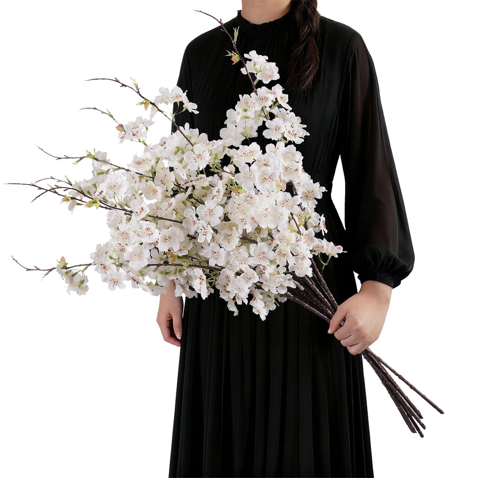 ENALGRE silk cherry blossom branch in white adds a delicate touch to any room.