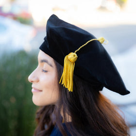 Endea Graduation ceremony setting shows dignified presence beside diploma