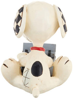 Enesco Jim Shore Peanuts figure typing at a typewriter, perfect for collectors.