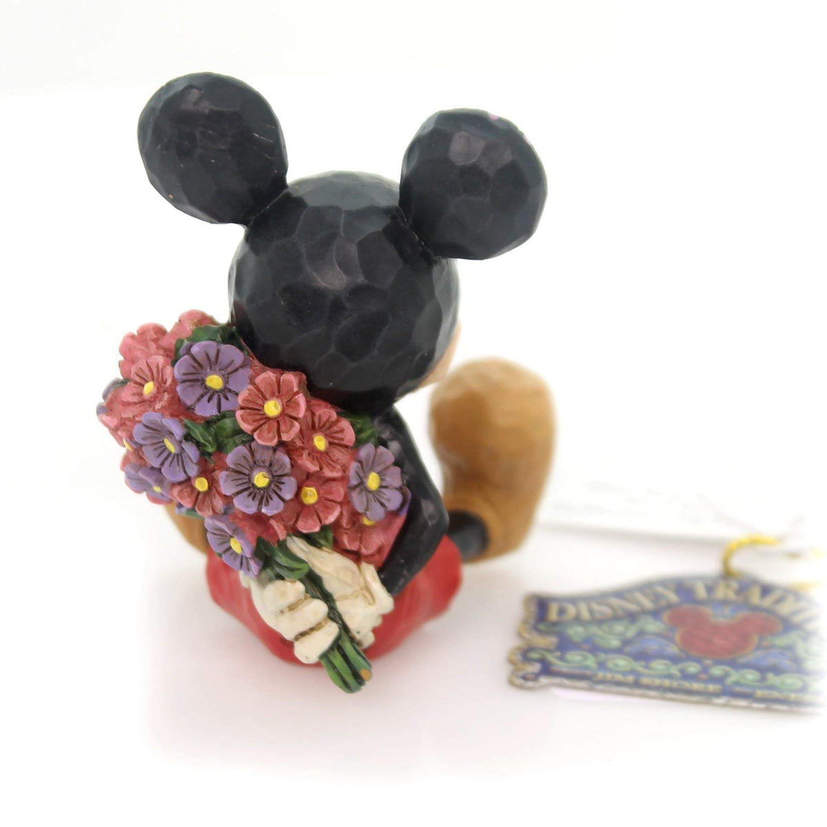 Enesco Mickey with bouquet behind his back, ready to surprise Minnie on display.