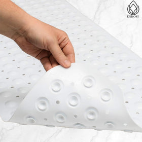 ENKOSI bath mat with 200 suction cups for strong grip on flat floors.
