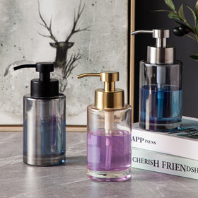 Premium glass bottle and pump detail on the Enra Gold dispenser.