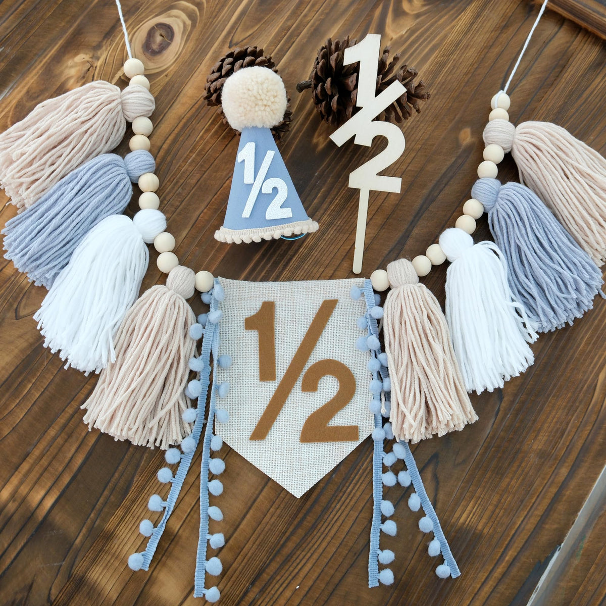 Ereniko half birthday banner for baby boy with blue and khaki tassels.