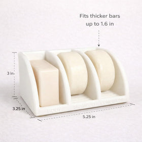 Three upright slots save space and keep bars within reach with wet hands.