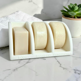 Essence & Abode Jade White shampoo bar holder keeps bars dry after use.