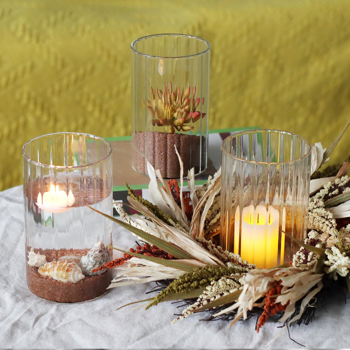 Etolies floating candle display inside a ribbed cylinder vase