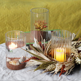 Etolies floating candle display inside a ribbed cylinder vase